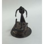 A miniature silver table toy of a figure mounted w