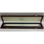 A solid silver presentation ruler in wooden fitted