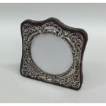 A small shaped silver picture frame decorated with