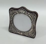 A small shaped silver picture frame decorated with