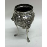 A Continental silver three legged vase embossed wi