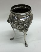 A Continental silver three legged vase embossed wi