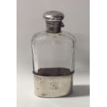 An Edwardian silver and glass flask. London. Est.