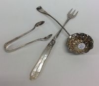 A silver ladle together with a pickle fork, and su