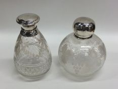 Two etched glass and silver mounted scent bottles.