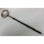 A good quality large Georgian silver toddy ladle w