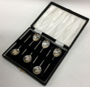 A boxed set of six silver bean top coffee spoons.