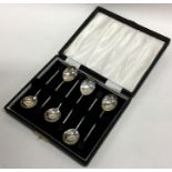 A boxed set of six silver bean top coffee spoons.