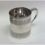 A Georgian silver mug with tapering reeded sides.