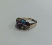 A large 9 carat muti-coloured stone cluster ring i