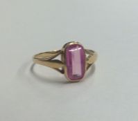 An unusual 18 carat pink single stone ring. Approx