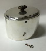 A plain oval Georgian silver tea caddy with flush