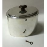 A plain oval Georgian silver tea caddy with flush