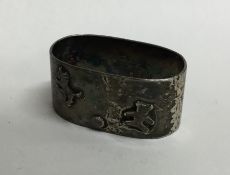 A child's silver napkin ring decorated with a tedd