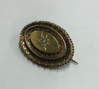 A Victorian 15 carat gold oval brooch decorated wi