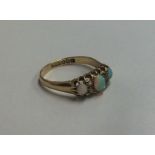 An opal and diamond seven stone ring in claw mount