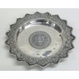 A circular Persian silver shallow dish with shaped
