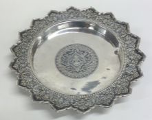 A circular Persian silver shallow dish with shaped