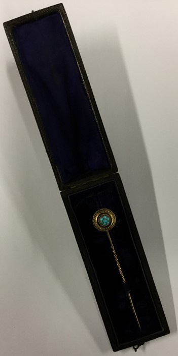 A cased gold mourning stick pin set with central turquoise
