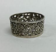 A Chinese silver tealight holder. Punched to inter
