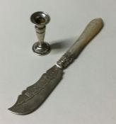 A small silver candlestick together with a butter