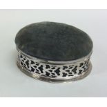 An oval silver pin cushion / jewellery box with sc
