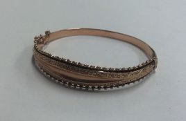 A 9 carat tapering bangle with concealed clasp. Ap