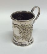 A silver plated embossed christening cup decorated