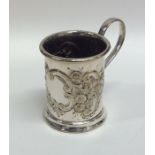 A silver plated embossed christening cup decorated