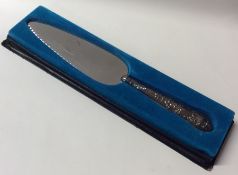 A cased silver Kings' pattern cake knife. London.