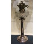 A tall Edwardian silver oil lamp on hexagonal base