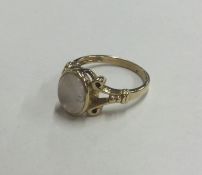 A 9 carat single stone ring with ball decoration.