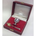 A silver egg cup together with a matching silver s