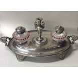 An attractive silver plated two bottle inkstand wi