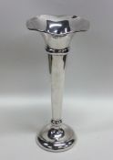A tall silver spill vase with shaped edge. Birming