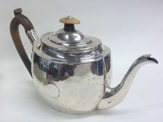 A large plain oval Georgian silver teapot. London.