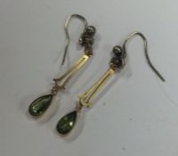 A pair of peridot and pearl drop earrings. Approx.