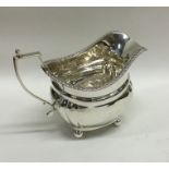 An Edwardian silver cream jug with gadroon rim. Lo