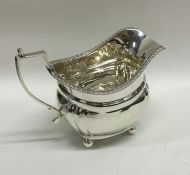 An Edwardian silver cream jug with gadroon rim. Lo