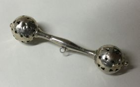 An Edwardian silver rattle of shaped form. Approx.