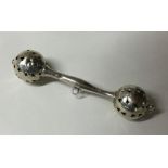 An Edwardian silver rattle of shaped form. Approx.