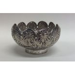 An Indian silver bowl with shaped rim mounted with