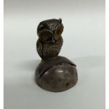 A novelty silver menu holder in the form of an owl