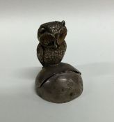 A novelty silver menu holder in the form of an owl