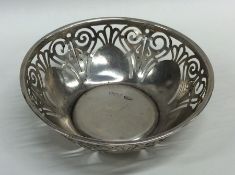 A circular silver bonbon dish with pierced decorat