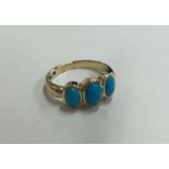 A 9 carat three stone turquoise ring in rubover mo