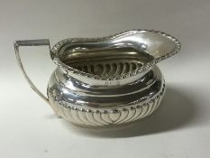 A silver half fluted sugar bowl with gadroon rim.