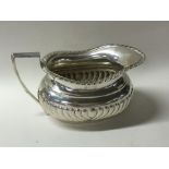 A silver half fluted sugar bowl with gadroon rim.