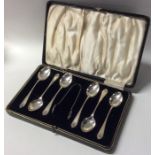 A boxed set of six silver coffee spoons and tongs.