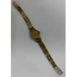 OMEGA: A lady's 9 carat wristwatch on mesh strap.